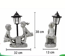 Load image into Gallery viewer, Solar Light Boy & Girl Seesaw Stone Effect Garden Ornament