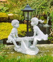 Load image into Gallery viewer, Solar Light Boy and Girl Seesaw Stone Effect Garden Ornament