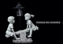 Load image into Gallery viewer, Solar Light Boy &amp; Girl Seesaw Stone Effect Garden Ornament