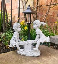Load image into Gallery viewer, Solar Light Boy and Girl Seesaw Stone Effect Garden Ornament